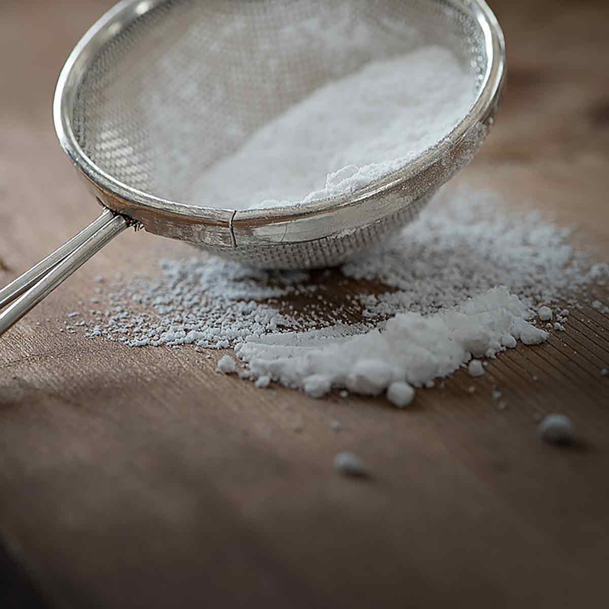 A Sieve Full Of Icing Sugar