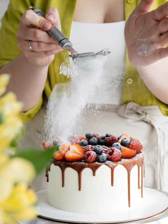 Dusting Icing Sugar Over A Cake
