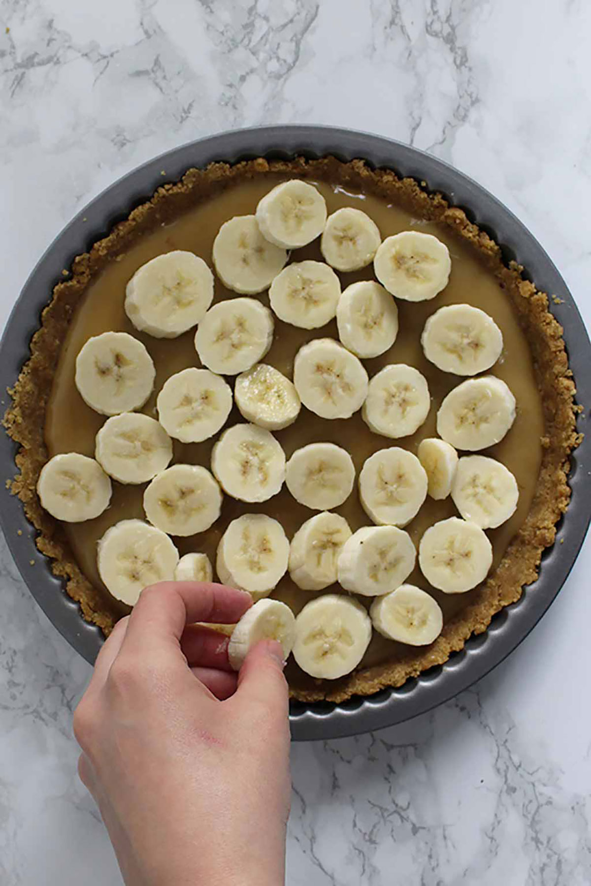 Placing Bananas On Top Of The Caramel
