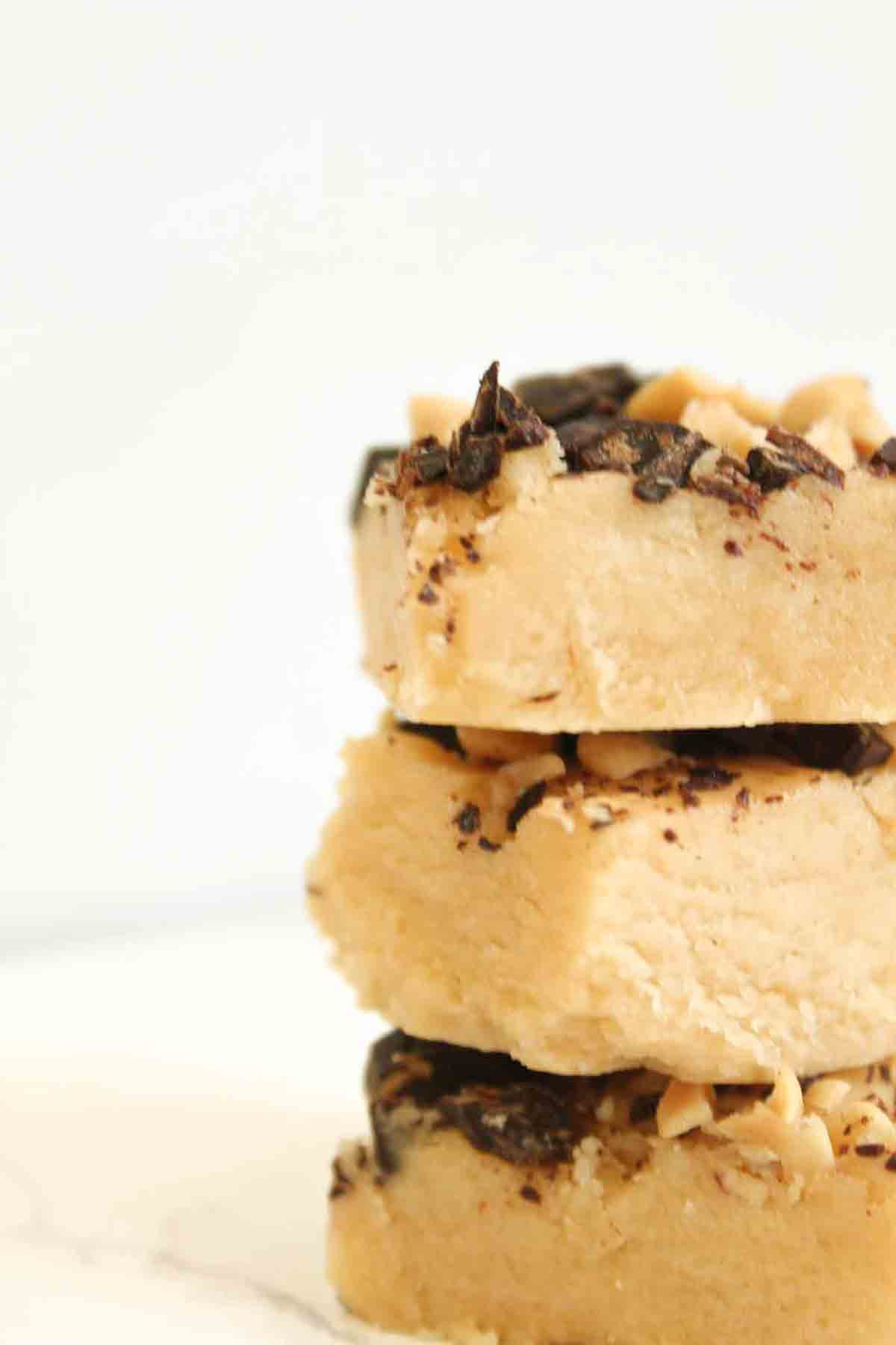 3 Pieces Of Vegan Peanut Butter Fudge Stacked On Top Of One Another