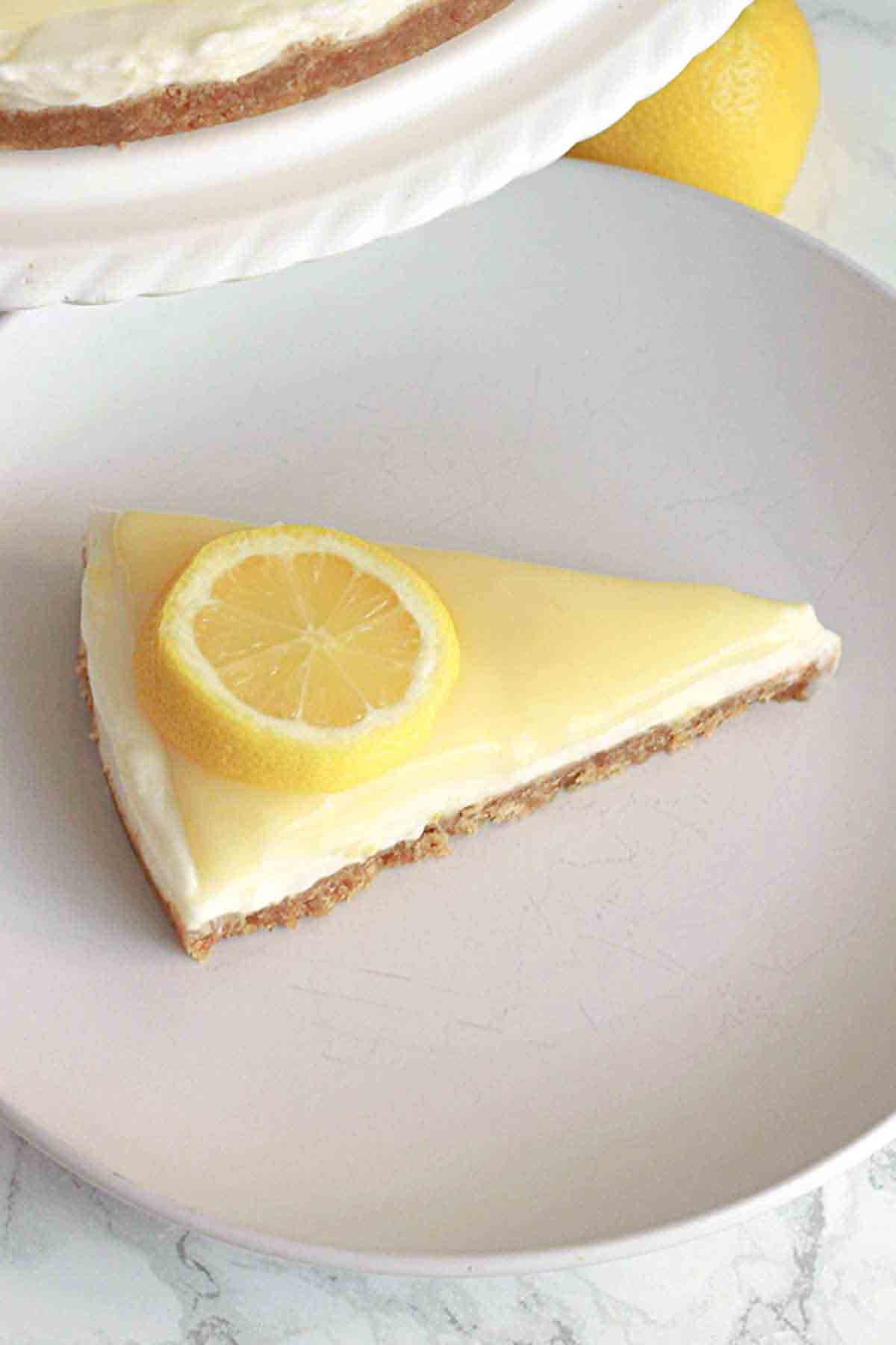 A Slice Of Vegan Lemon Cheesecake On A Plate