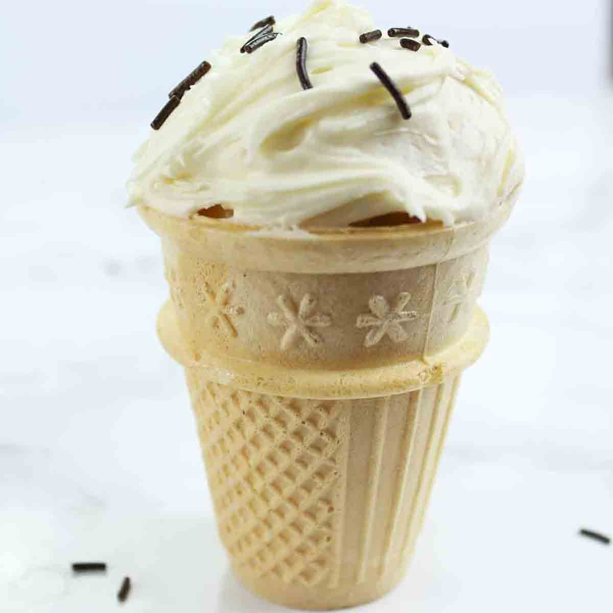 https://bakedbyclo.com/wp-content/uploads/2023/01/a-vegan-ice-cream-cone-cupcake-with-dairy-free-buttercream-on-top.jpg