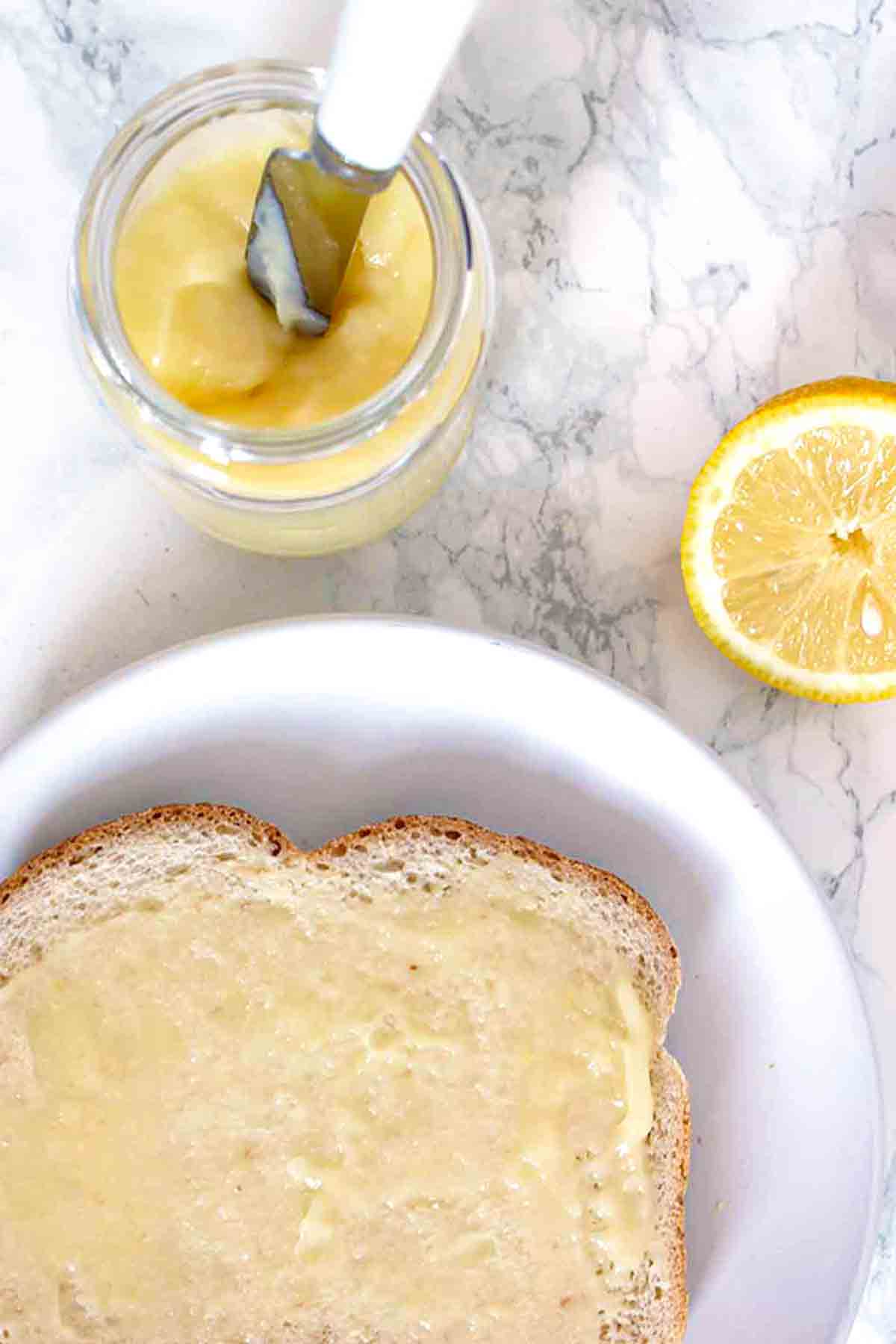 Eggless Lemon Curd In A Jar Beside Bread