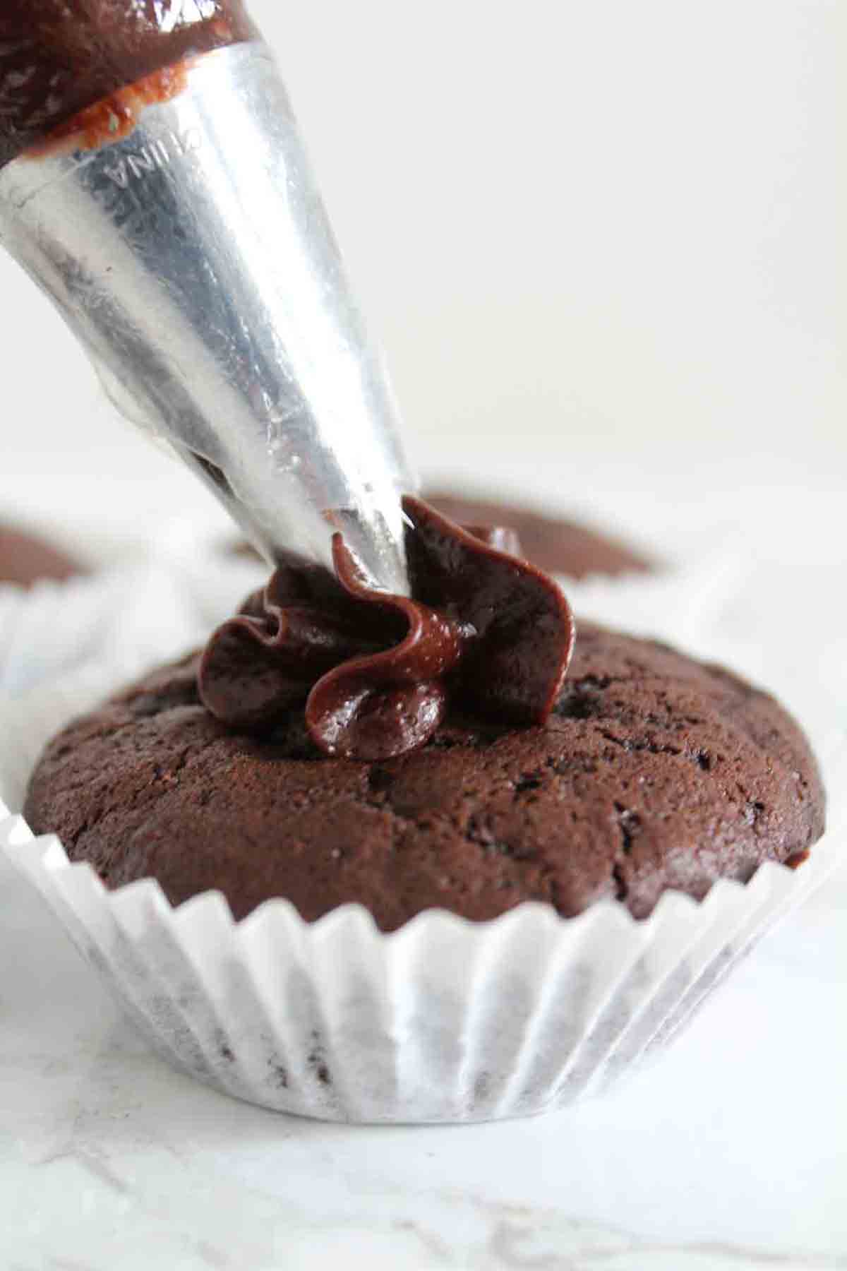 Piping Dairy Free Chocolate Buttercream Onto Eggless Cucpake