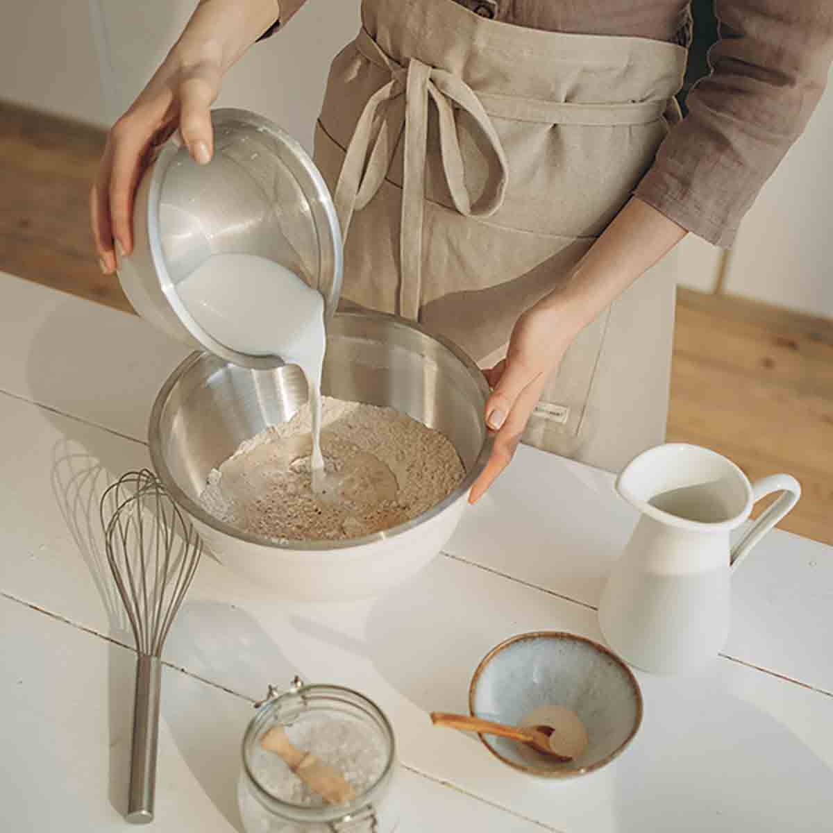 Pouring Vegan Milk Alternative Into A Baking Bowl