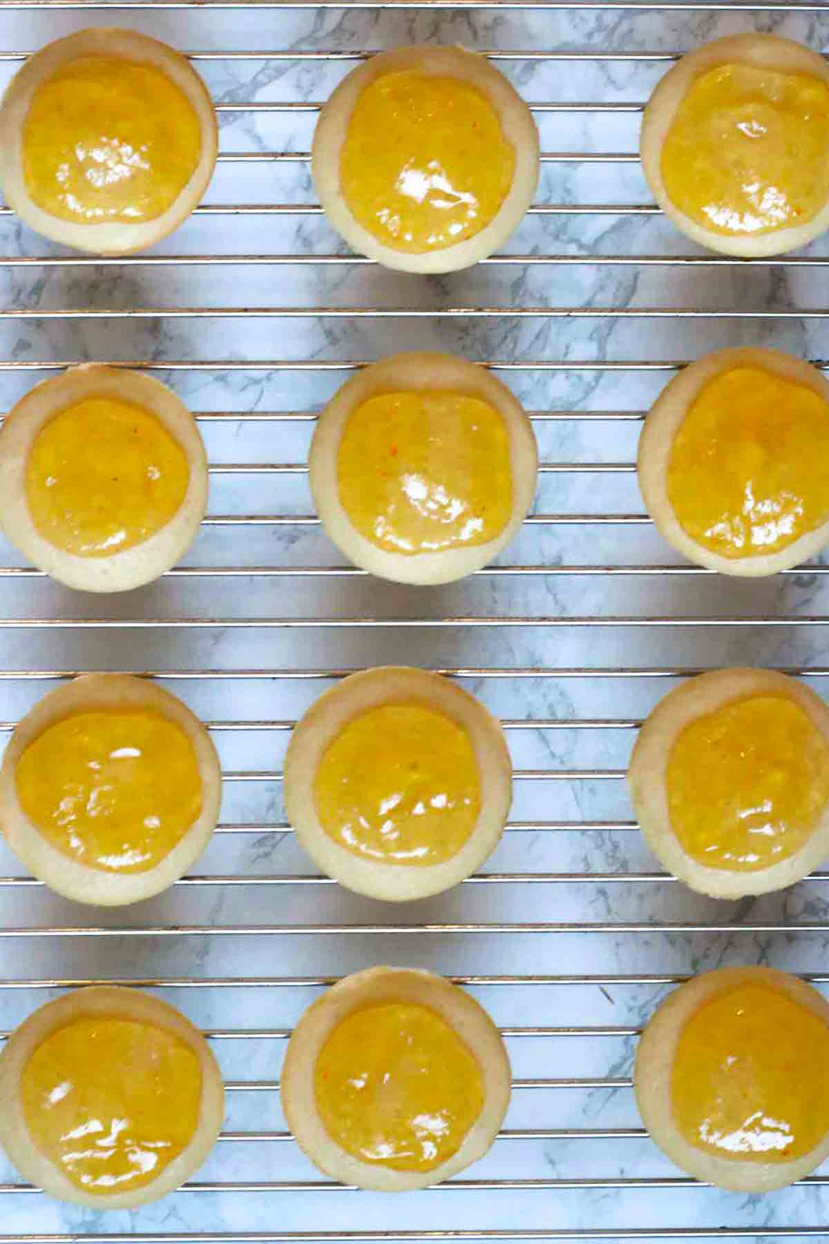 Round Cakes On A Cooling Rack With Circles Of Marmalade On Top