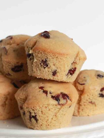 Vegan Cranberry Muffins On A White Cake Stand