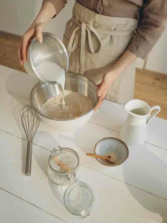 Vegan Milk For Baking Thumbnail Image Of A Woman Pouring Milk Into A Bowl