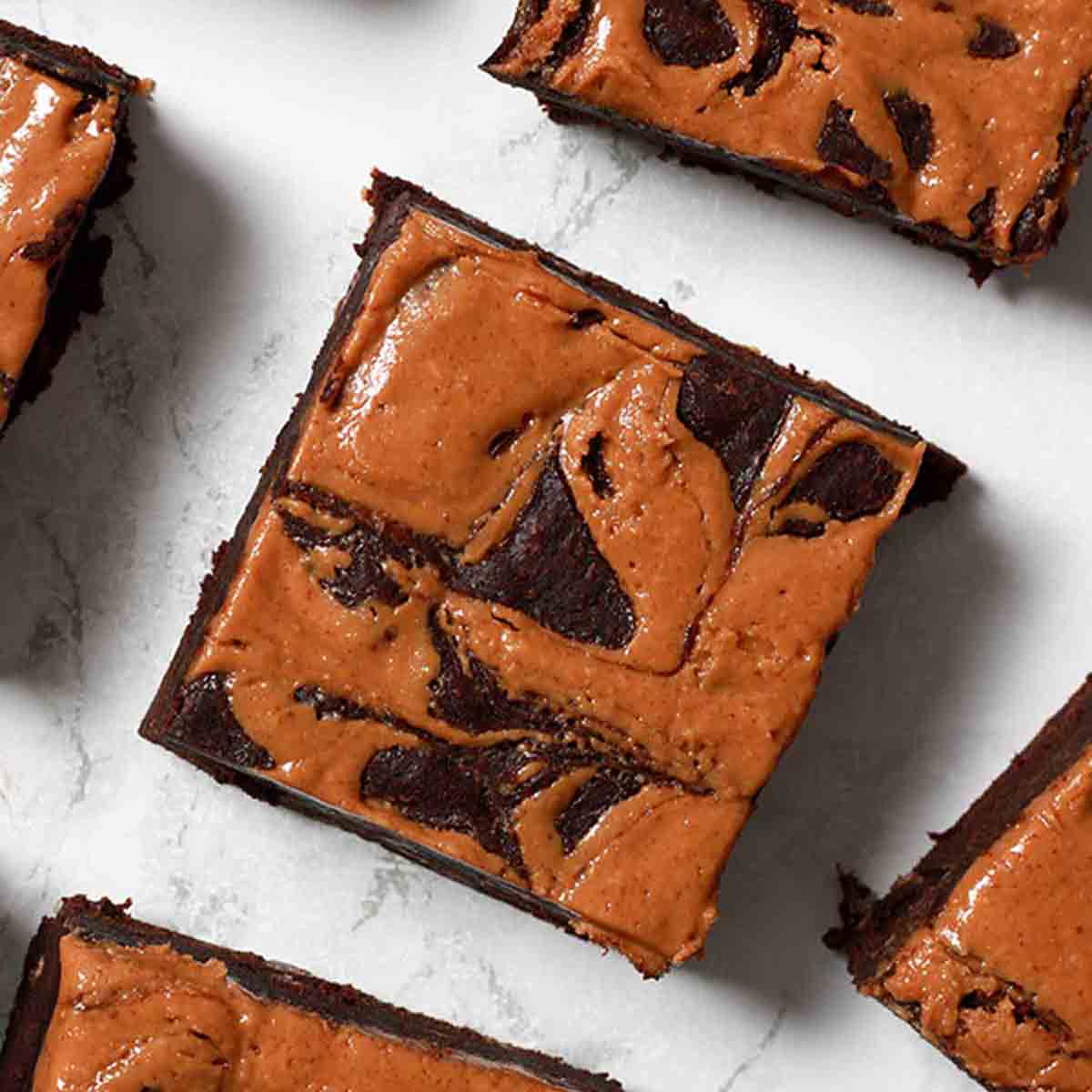 Vegan Peanut Butter Brownies Lying On A White Surface