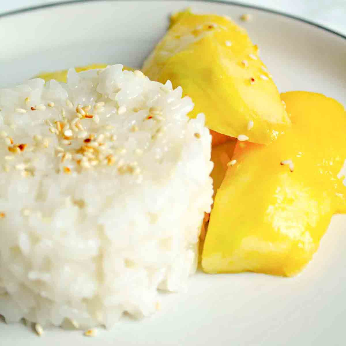 A Mound Of Vegan Sticky Rice With Mango On The Side