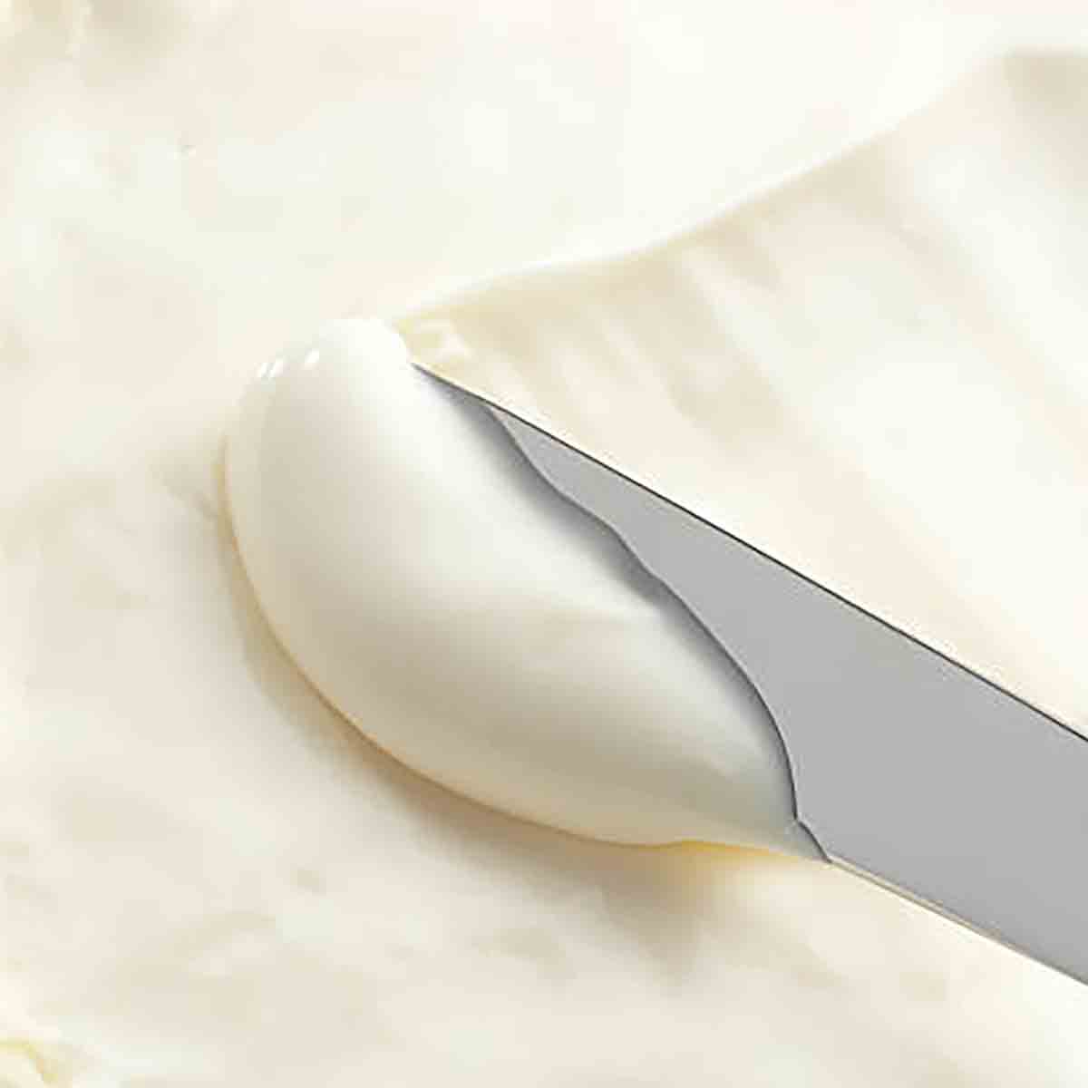 Vegan Cream Cheese Being Spread With A Knife