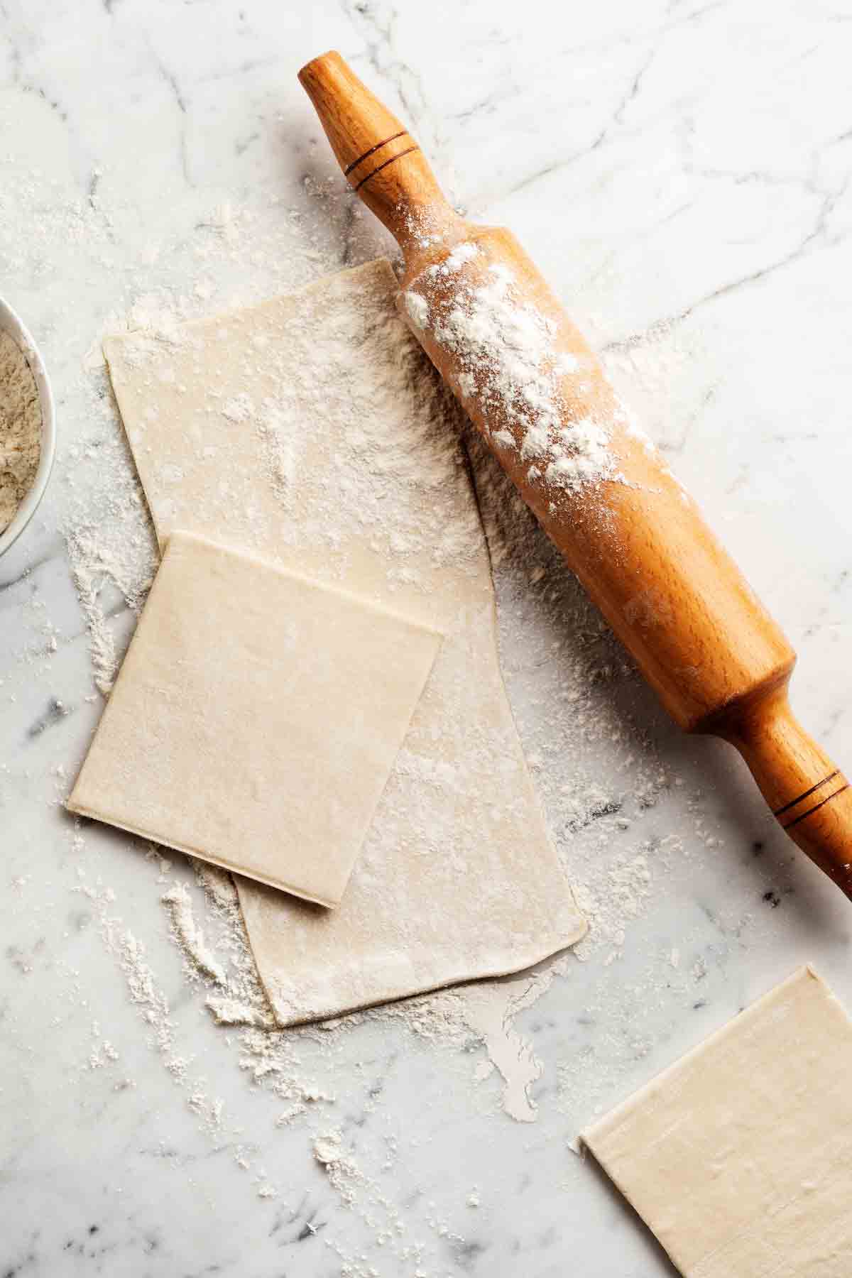 Block Of Pastry On A Floured Beside A Rolling Pin