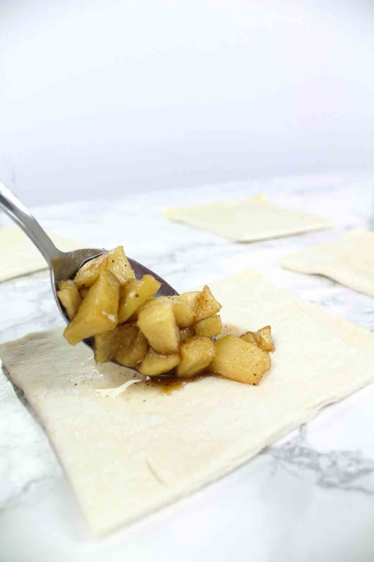 Placing Apple Chunks Into The Pastry Squares