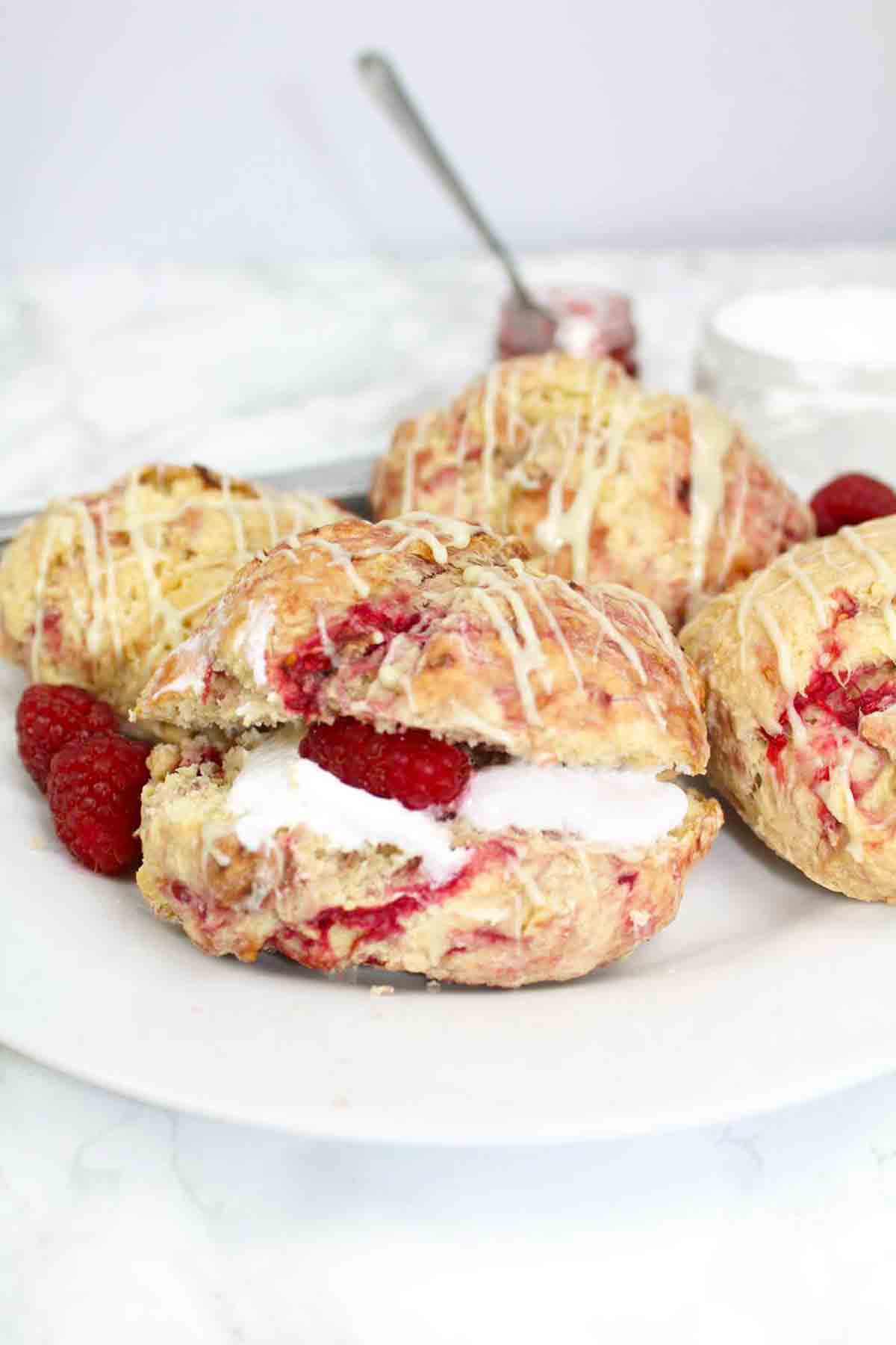 Vegan Raspberry Scones On A Plate Drizzle With Dairy Free White Chocolate