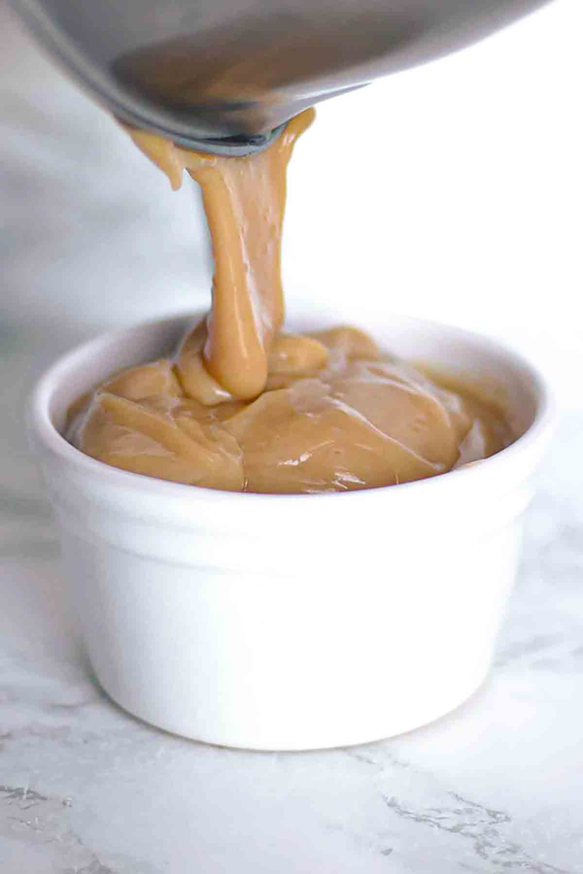 Thick Vegan Caramel Being Poured Into A Ramekin