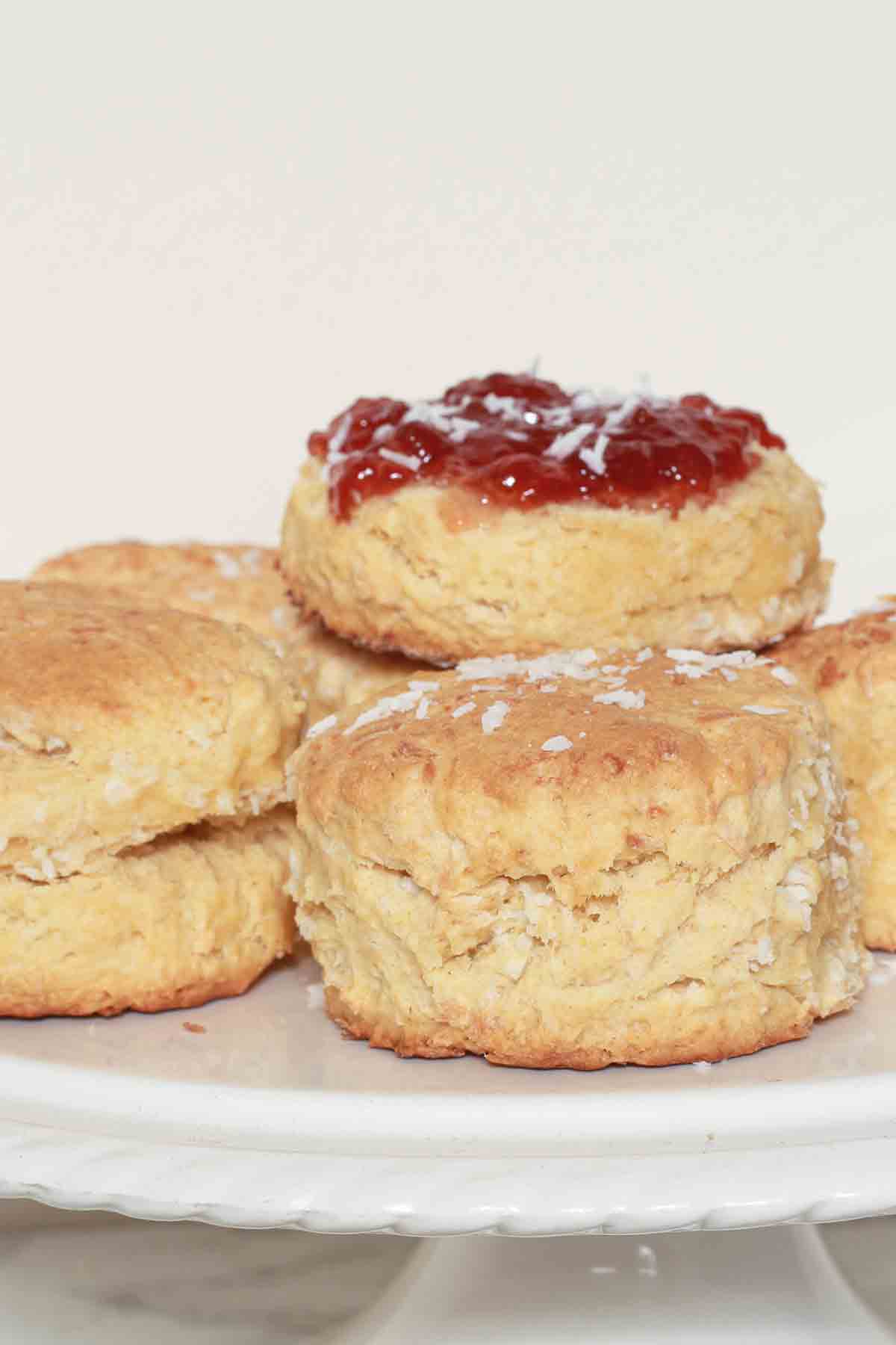 Jam Covered Eggless Coconut Scone On Top Of A Scone Stack