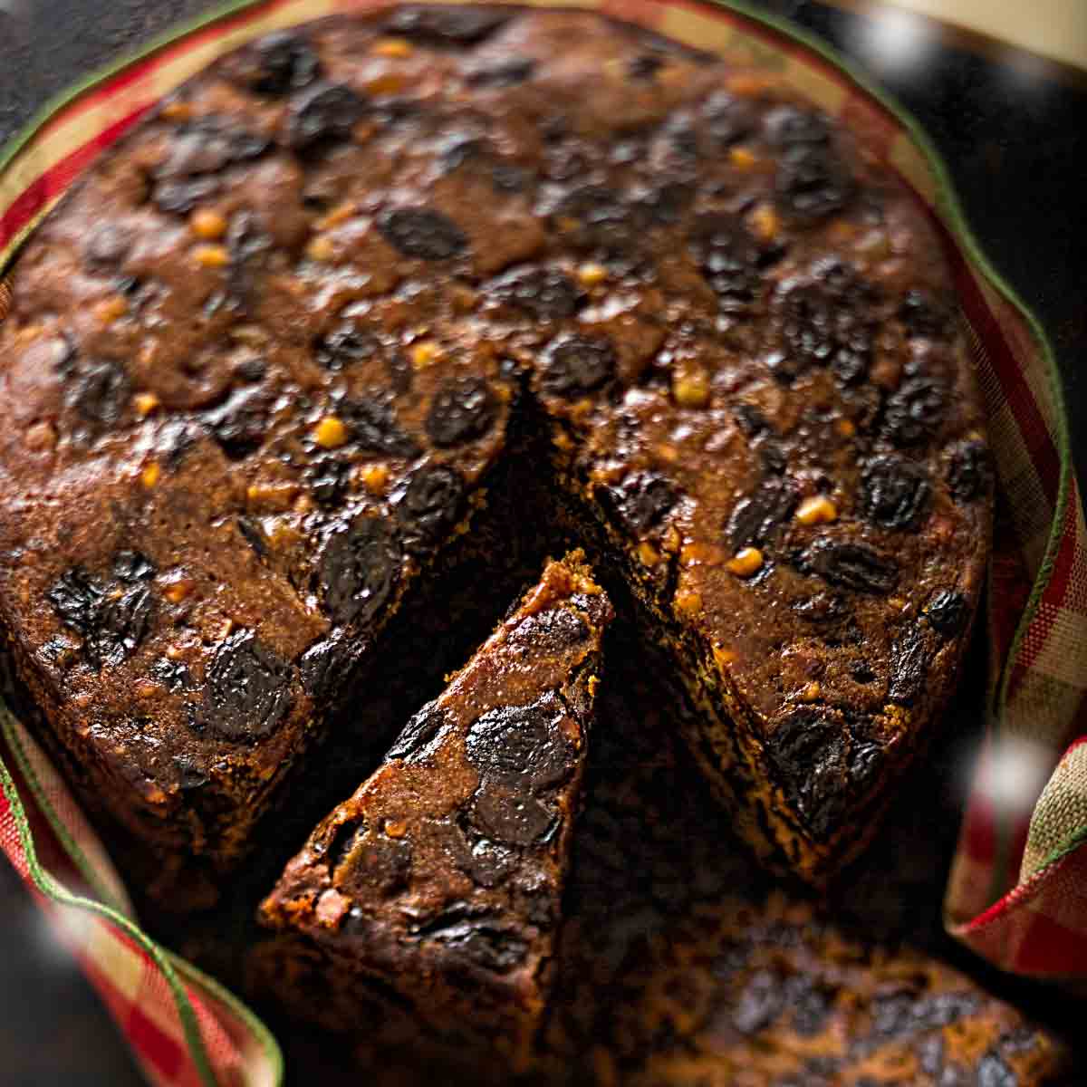 Close Up Of Fruit Cake With A Slice Being Taken Out