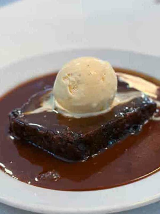 Is Sticky Toffee Pudding Vegan Thumbnail Image Of Pudding On Plate With Ice Cream On Top