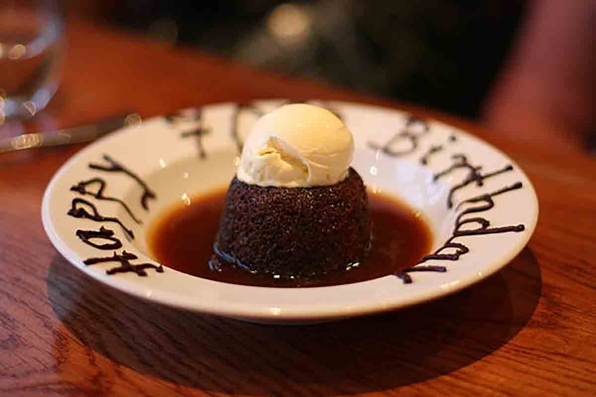 Sticky Toffee Pudding In Bowl With Ice Cream On Top