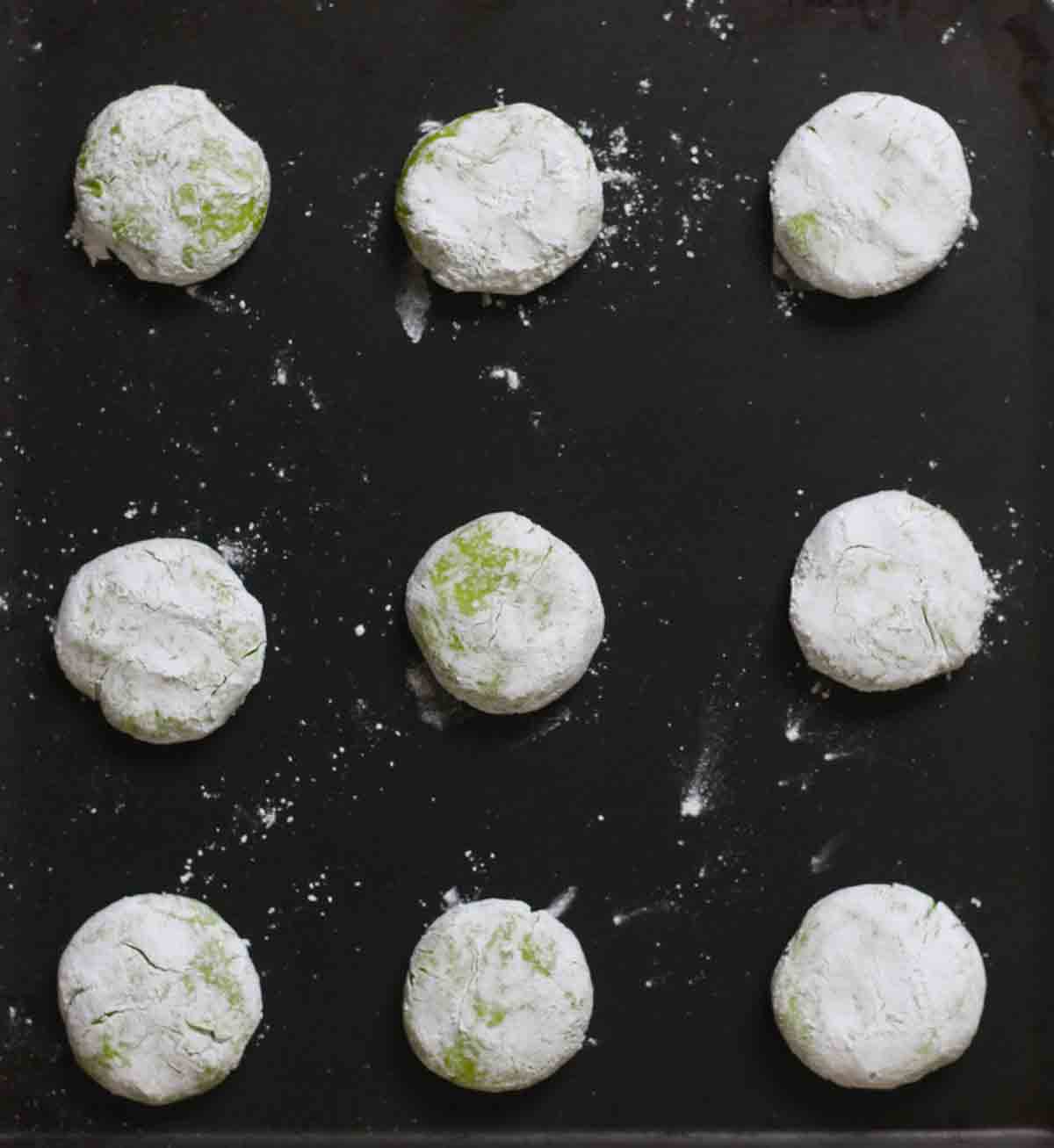 Balls Of Green Dough Covered With Icing Sugar