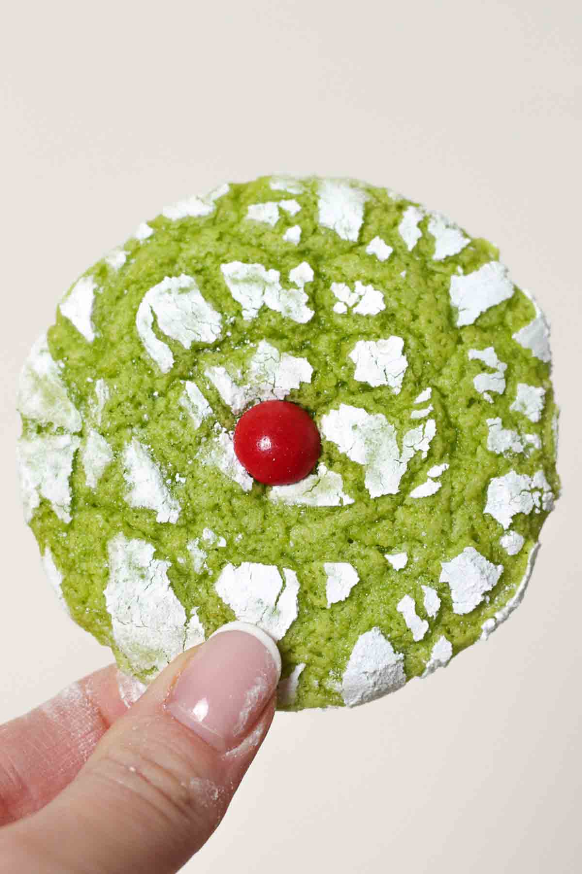 Hand Holding A Green And Red Cookie