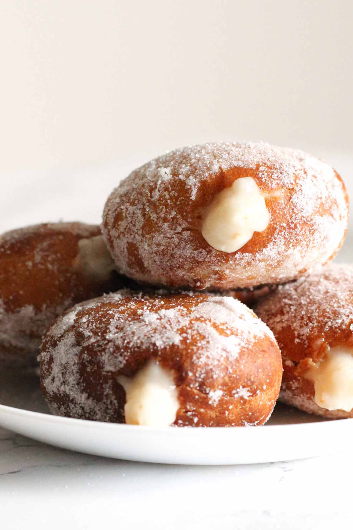 Pile of Eggless Air Fryer Donuts Filled With Dairy Free Cream Custard