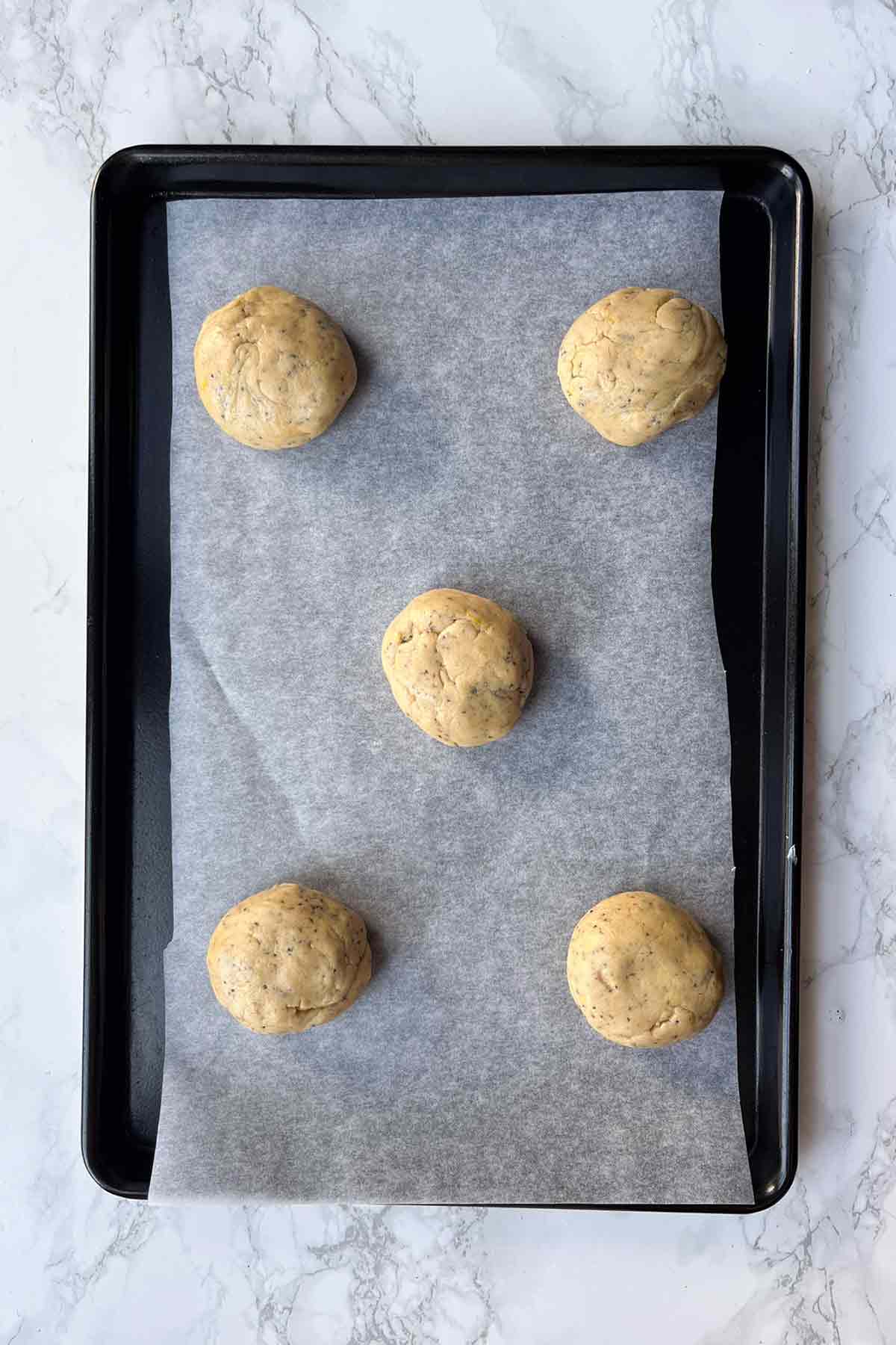 Balls Of Cookie Dough On Lined Tray