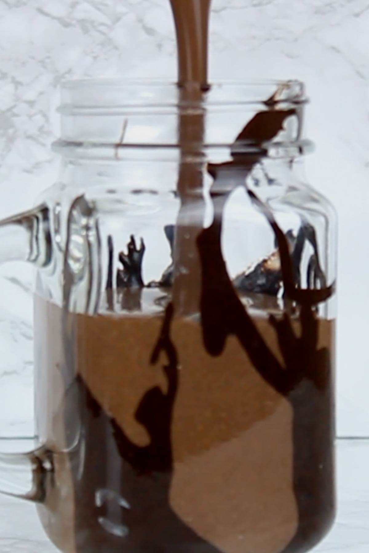 Pouring Dairy Free Oreo Milkshake Into A Glass