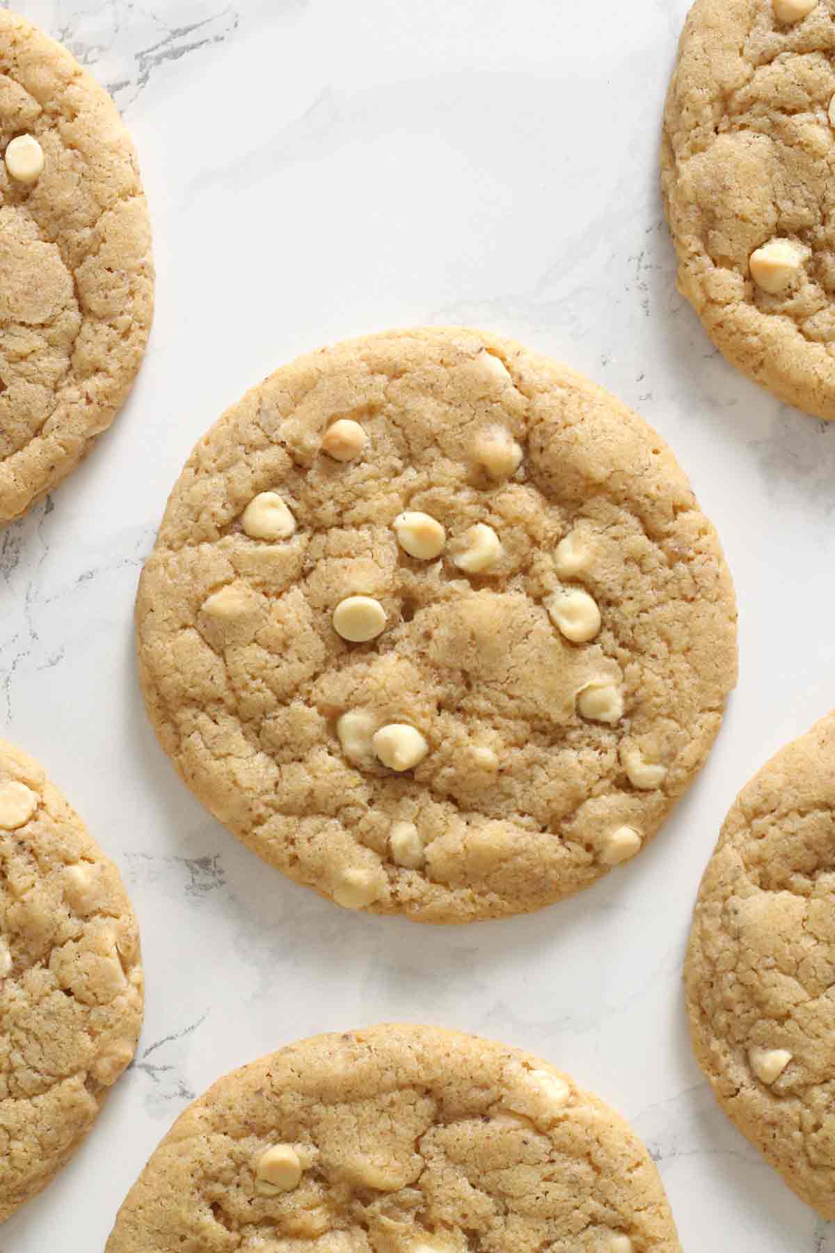Vegan White Chocolate Chip Cookies Laying On A White Surface