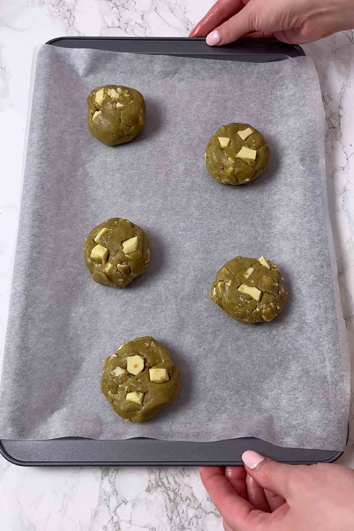 Balls Of Cookie Dough On Baking Tray